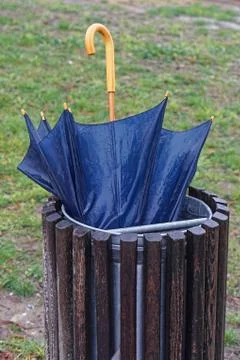 Umbrella in garbage Stock Photos