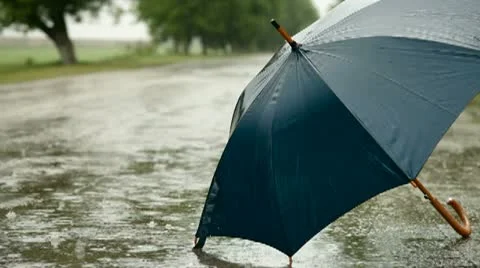 Umbrella On The Road Under Rain Stock Footage