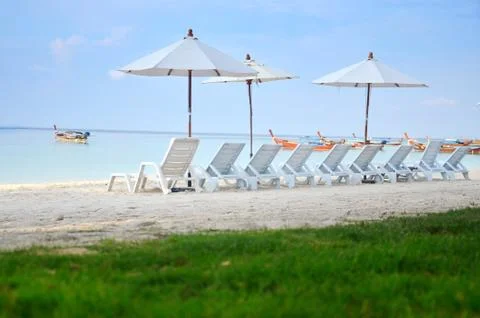 Umbrella on sand beach Stock Photos