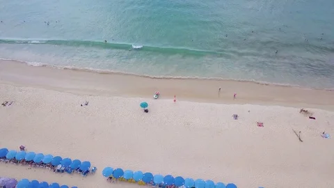 Umbrellas and coconut trees is located beachside at  Phuket Thailand 库存影片 83333931