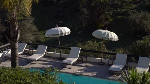 Umbrellas and sunbeds by the pool Stock-Footage 260805851