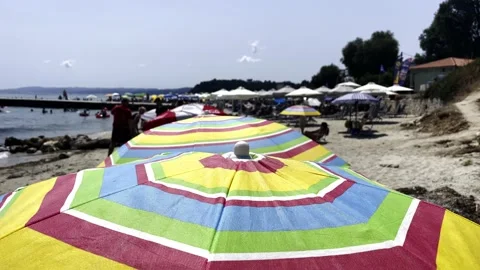 Umbrellas on the beach in slow motion Stock Footage 157862207