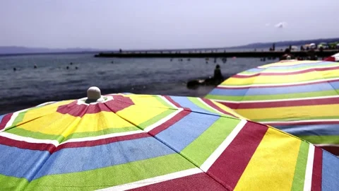 Umbrellas on the beach in slow motion Stock Footage 157862449