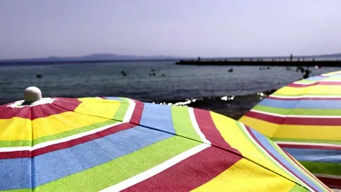 Umbrellas on the beach in slow motion Stock Footage 157862671