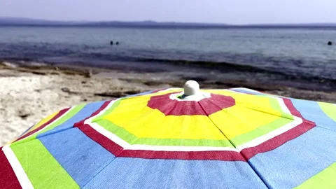 Umbrellas on the beach in slow motion Stock Footage 157862897