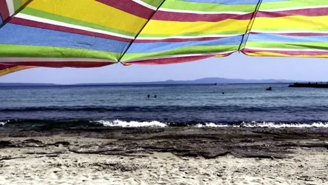 Umbrellas on the beach in slow motion Stock Footage 157863608