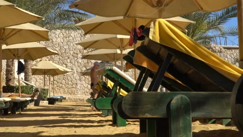 Umbrellas on the beach. The sunbeds on the beach Stock Footage 89922444