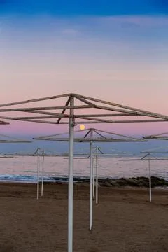 Umbrellas on the beach at sunset. Stock Photos