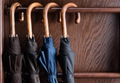 Umbrellas on boutique store display Different classic wooden handle walkin... Photos
