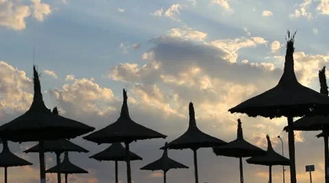 Umbrellas, bright sun light under the clouds and waves (sound) Stock Footage 12274267