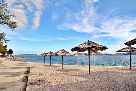 Umbrellas on an empty beach Stock Photos