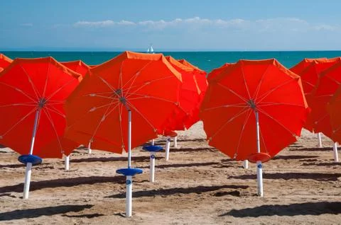 Umbrellas on Sandy Beach Stock Photos