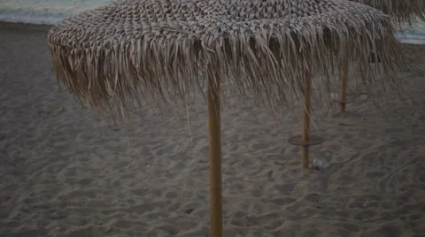 Umbrellas on a sea side in the evening light Stock Footage 67676059