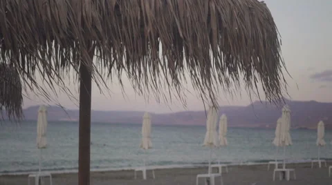 Umbrellas on a sea side in the evening light Video stock 67676111