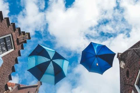Umbrellas suspended between the roofs Stock Photos