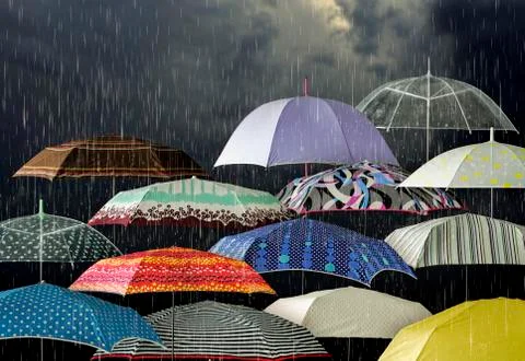 Umbrellas under raindrops Stock Photos