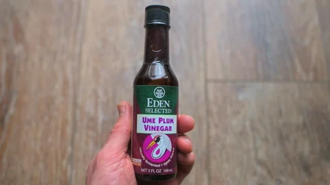 Ume plum vinegar bottle macro closeup condiment seasoning by Eden brand Stock Footage 336782565