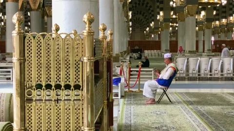 Umrah pilgrim reading the Quran inside masjid Stock Footage 332964955
