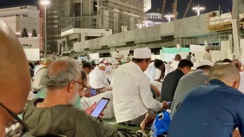 Umrah pilgrims are waiting for prayer Stock Footage 332588076