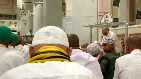 Umrah pilgrims sitting in prayer rows inside Masjid Stock Footage 332593478