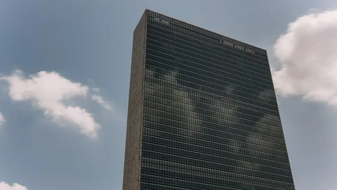 UN building facade with clouds in Manhattan - New York - USA Stock Footage 114080694