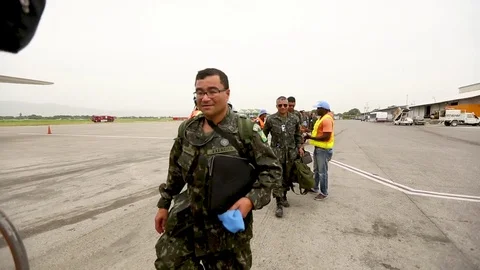 UN peacekeepers line up and board a plane Stock Footage