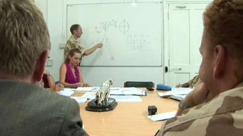 UN United Nations peacekeepers meeting with whiteboard diagram Stock Footage