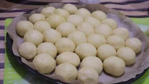 Unbaked bread balls in tray Stock Footage 327352160