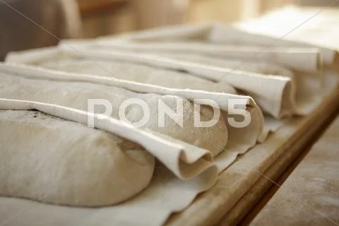 Unbaked bread on folded linen cloth Stock Photos