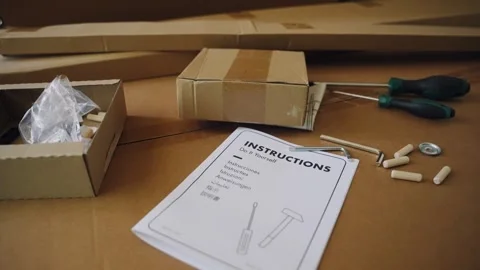 Unboxing and assembling flat pack furniture at home 動画素材 347030168