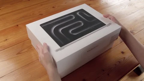 Unboxing the new silver MacBook Pro with the M4 Pro processor. Stock Footage 314518327