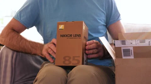 Unboxing Nikon 85mm Lens from Amazon Stock Footage 308449111