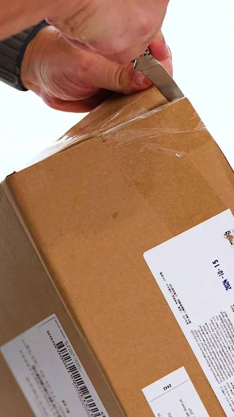 Unboxing a Package with a Cutting Knife Stock Footage 307290212