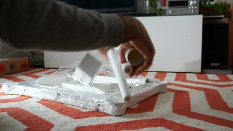 Unboxing unpacking assembling Ikea Utter plastic table Stock Footage 118369629