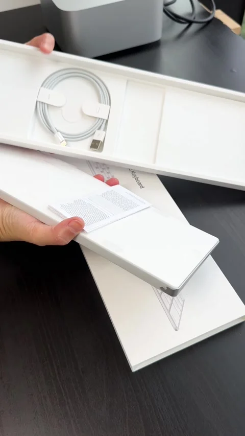 Unboxing a Wireless Keyboard with Numeric Keypad on Desk Stock Footage 318434660