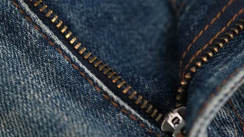 Unbuttoned zipper on jeans rotating. concept of tailoring closure denim texture Stock Footage 246785357