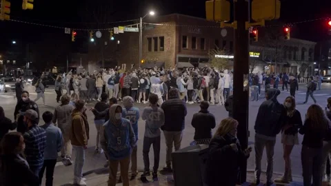 UNC Students Rush Franklin st after Duke Victory during COVID - Slow Motion Video stock 149930226