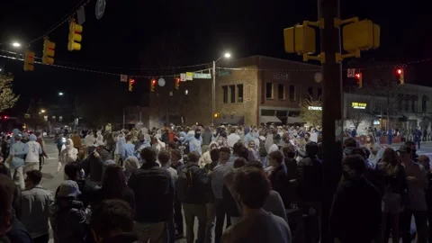 UNC Students Rush Franklin st after Duke Victory during COVID - Slow Motion Video stock 149930273