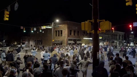 UNC Students Rush Franklin st after Duke Victory during COVID - Slow Motion Video stock 149930297