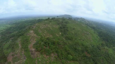 Uncivilised african rocky mountain and forest landscape aerial footage Stock Footage