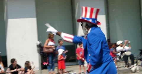 Uncle Sam cheering people at Independence Day parade in Los Angeles, 4K Stock Footage