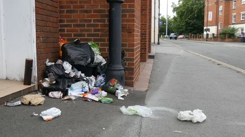 Uncollected refuse spills out over city street, Trowbridge, UK Stock Footage 77783689