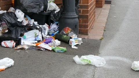 Uncollected refuse spills out over city street, Trowbridge, UK Stock Footage 77783957