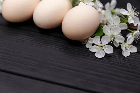 Uncolored natural easter eggs on black wooden background. Happy easter Fotos de archivo