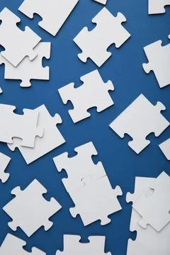 Uncompleted elements of a white puzzle on blue background. 스톡 사진