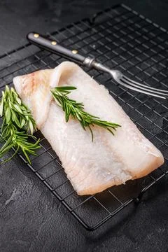 Uncooked Atlantic cod fillet, raw fish ready to be seasoned and transformed.. Stock Photos
