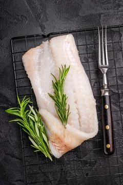 Uncooked Atlantic cod fillet, raw fish ready to be seasoned and transformed.. Stock Photos