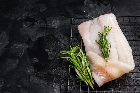 Uncooked Atlantic cod fillet, raw fish ready to be seasoned and transformed.. Stock Photos