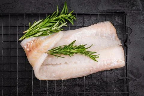 Uncooked Atlantic cod fillet, raw fish ready to be seasoned and transformed.. Stock Photos