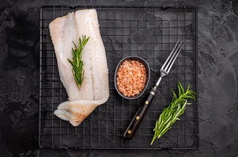 Uncooked Atlantic cod fillet, raw fish ready to be seasoned and transformed.. Stock Photos